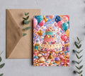 Colorful three-tier birthday cake greeting card with balloons and kraft envelope